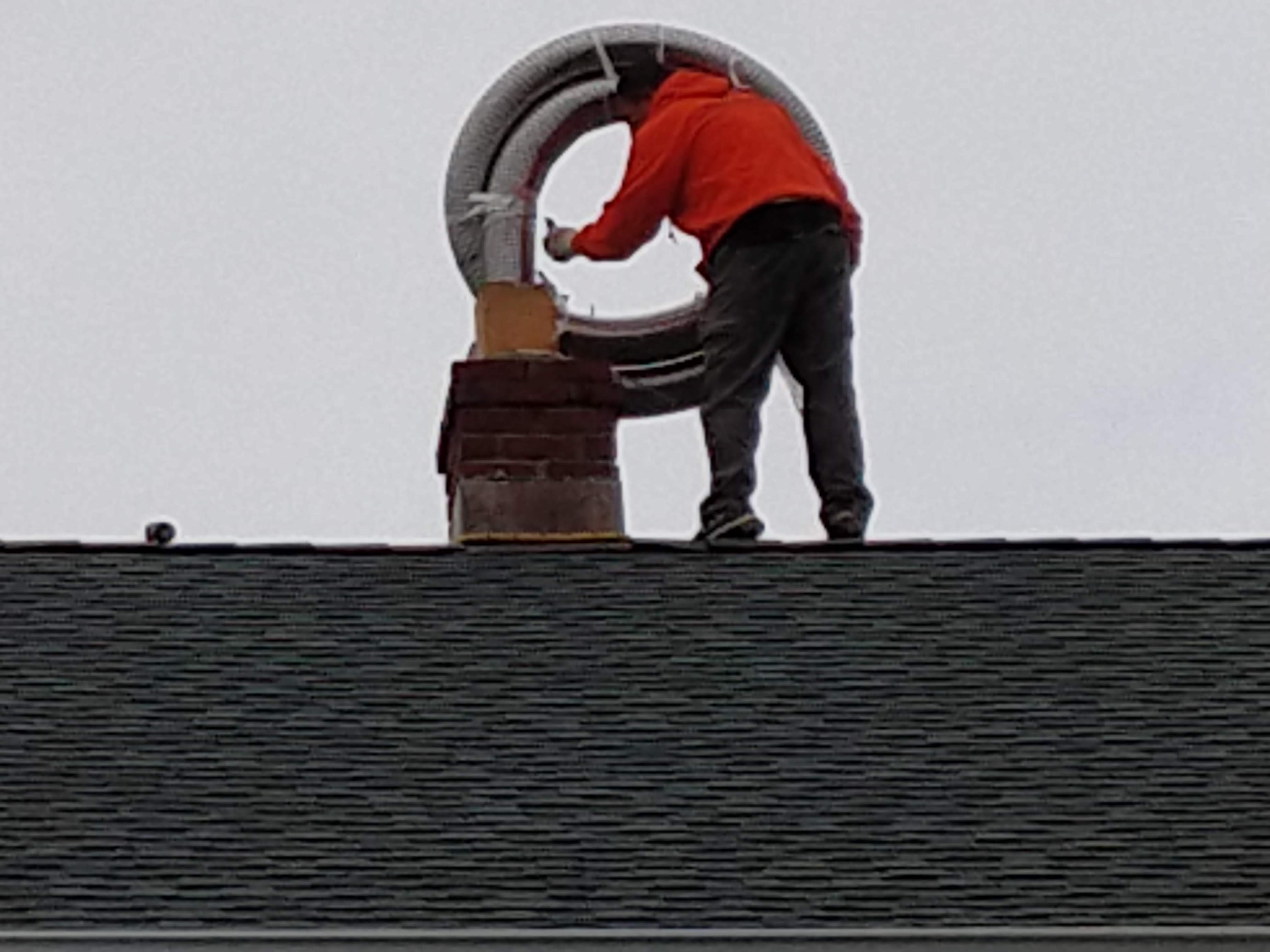 Flexible stainless chimney liner being installed in Wantagh, New York